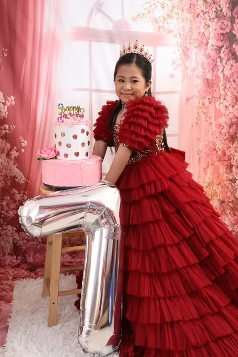 Kylie Rose beside her strawberry birthday cake and a number seven balloon