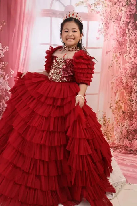 Kylie Rose smiling in her crimson ruffled gown